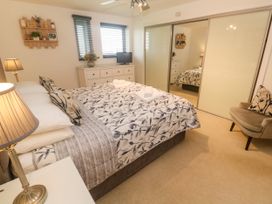A bedroom with a bed and television at Ocean Seven in Newquay