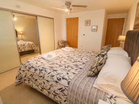 A bedroom with a double bed and wardrobe at Ocean Seven in Newquay