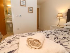 A bedroom with a towel on the bed at Ocean Seven in Newquay