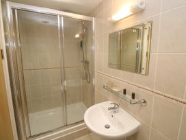A bathroom with a shower and sink at Ocean Seven in Newquay