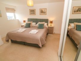 A bedroom with a bed and bedside table at Ocean Seven in Newquay
