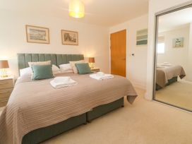 A bedroom with two beds and nightstands at Ocean Seven in Newquay
