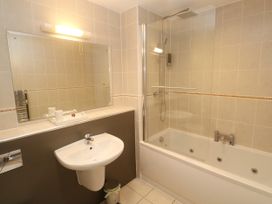 A bathroom with a sink, bath tub and shower at Ocean Seven in Newquay