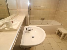 A bathroom with a sink and bath tub at Ocean Seven in Newquay