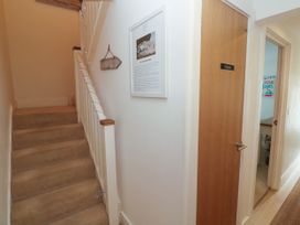 A hallway with stairs and a door labeled Private at Ocean Seven in Newquay