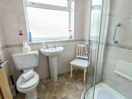 A bathroom with a shower and sink at Awelon in Rhos-On-Sea