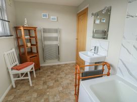 A bathroom with a sink and bath tub at Awelon in Rhos-On-Sea