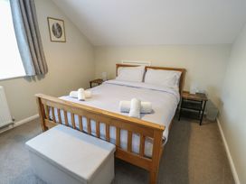 A bedroom with a bed and bedside table at Awelon in Rhos-On-Sea