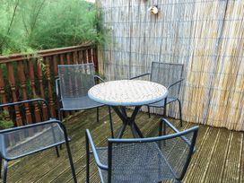 An outdoor seating area with a table and chairs at Awelon in Rhos-On-Sea