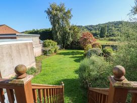 A garden with grass and trees at Awelon in Rhos-On-Sea