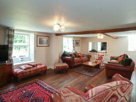 A living room with sofas and a coffee table at Plas Mawr in Groeslon