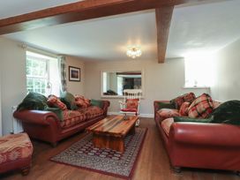 A living room with sofas and a coffee table at Plas Mawr in Groeslon