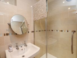 A bathroom with a sink and shower at Plas Mawr in Groeslon