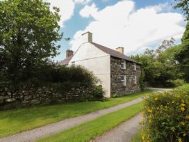 A house with a pathway and garden at Plas Mawr in Groeslon