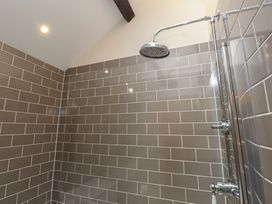 A shower with tiles and fixtures at Beudy'r Wennol in Groeslon