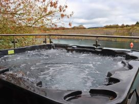 A hot tub overlooking water at Boavista in Carnforth