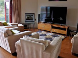 A living room with a sofa set and television at Boavista in Carnforth