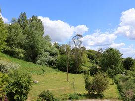 A garden with trees and grass at Pottery Barn in Branscombe