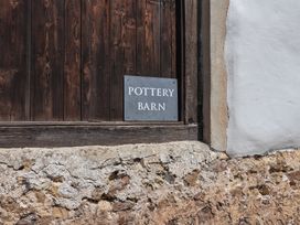 A sign that says Pottery Barn near a wooden wall at Pottery Barn Branscombe