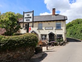 A building with a sign at The Fountain Head in Branscombe