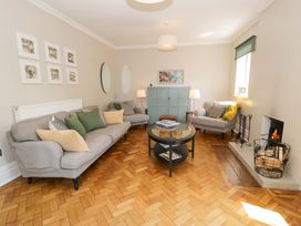 A living room with sofas and a fireplace at Coedfryn in Betws-y-Coed
