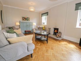A living room with a sofa and coffee table at Coedfryn in Betws-y-Coed