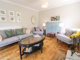 A living room with sofas and a coffee table at Coedfryn in Betws-y-Coed