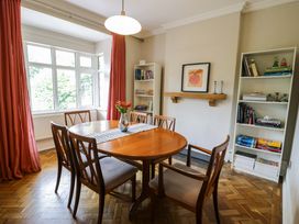 A dining room with a table and chairs at Coedfryn in Betws-y-Coed