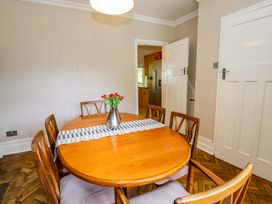 A dining room with a table and chairs at Coedfryn in Betws-y-Coed