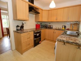 A kitchen with cabinets and appliances at Coedfryn in Betws-y-Coed