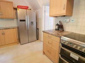 A kitchen with a fridge and stove at Coedfryn in Betws-y-Coed