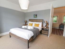 A bedroom with a double bed and nightstands at Coedfryn in Betws-y-Coed