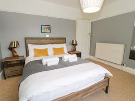 A bedroom with a bed and nightstands at Coedfryn in Betws-y-Coed
