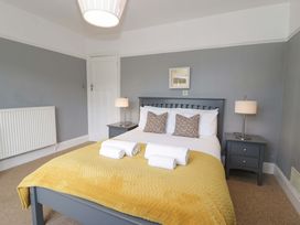 A bedroom with a bed and bedside table at Coedfryn in Betws-y-Coed