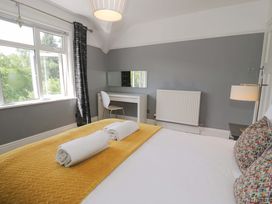 A bedroom with a bed and desk at Coedfryn Betws-y-Coed