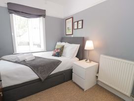 A bedroom with a bed and nightstand at Coedfryn in Betws-y-Coed
