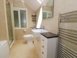 A bathroom featuring a sink, toilet, and shower at Coedfryn Betws-y-Coed