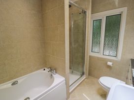 A bathroom with a bathtub and shower at Coedfryn in Betws-y-Coed