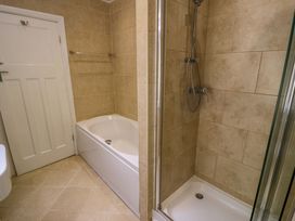 A bathroom with a bathtub and shower at Coedfryn in Betws-y-Coed