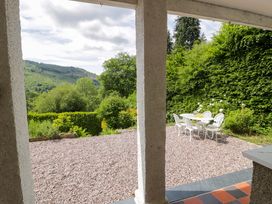 An outdoor seating area with a table and chairs at Coedfryn in Betws-y-Coed