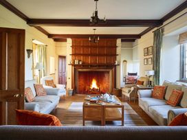 A living room with a fireplace and sofas at Great Bidlake Manor in Bridestowe, near Lydford