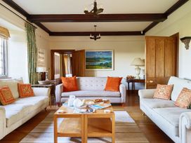 A living room with sofas and a coffee table at Great Bidlake Manor, Bridestowe, near Lydford