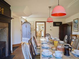 A dining room with a table set for breakfast at Great Bidlake Manor in Bridestowe, near Lydford