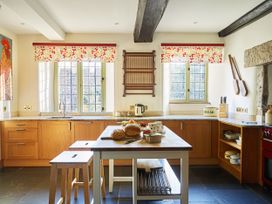 A kitchen with countertops and windows at Great Bidlake Manor, Bridestowe, near Lydford