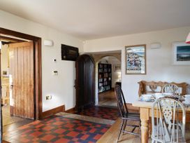 A dining room with a table and chairs at Great Bidlake Manor in Bridestowe, near Lydford