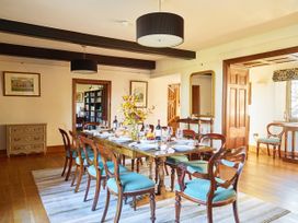 A dining room with a table set for dinner at Great Bidlake Manor in Bridestowe near Lydford