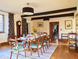 A dining room with a table and chairs at Great Bidlake Manor in Bridestowe, near Lydford
