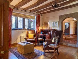 A living room with furniture and a light source at Great Bidlake Manor, Bridestowe, near Lydford