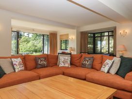 A living room with a sofa and coffee table at Sandsgate near Spinster's Rock, near Chagford