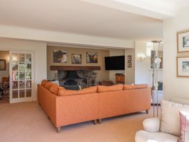 A living room with a sofa and fireplace at Sandsgate near Spinster's Rock, near Chagford